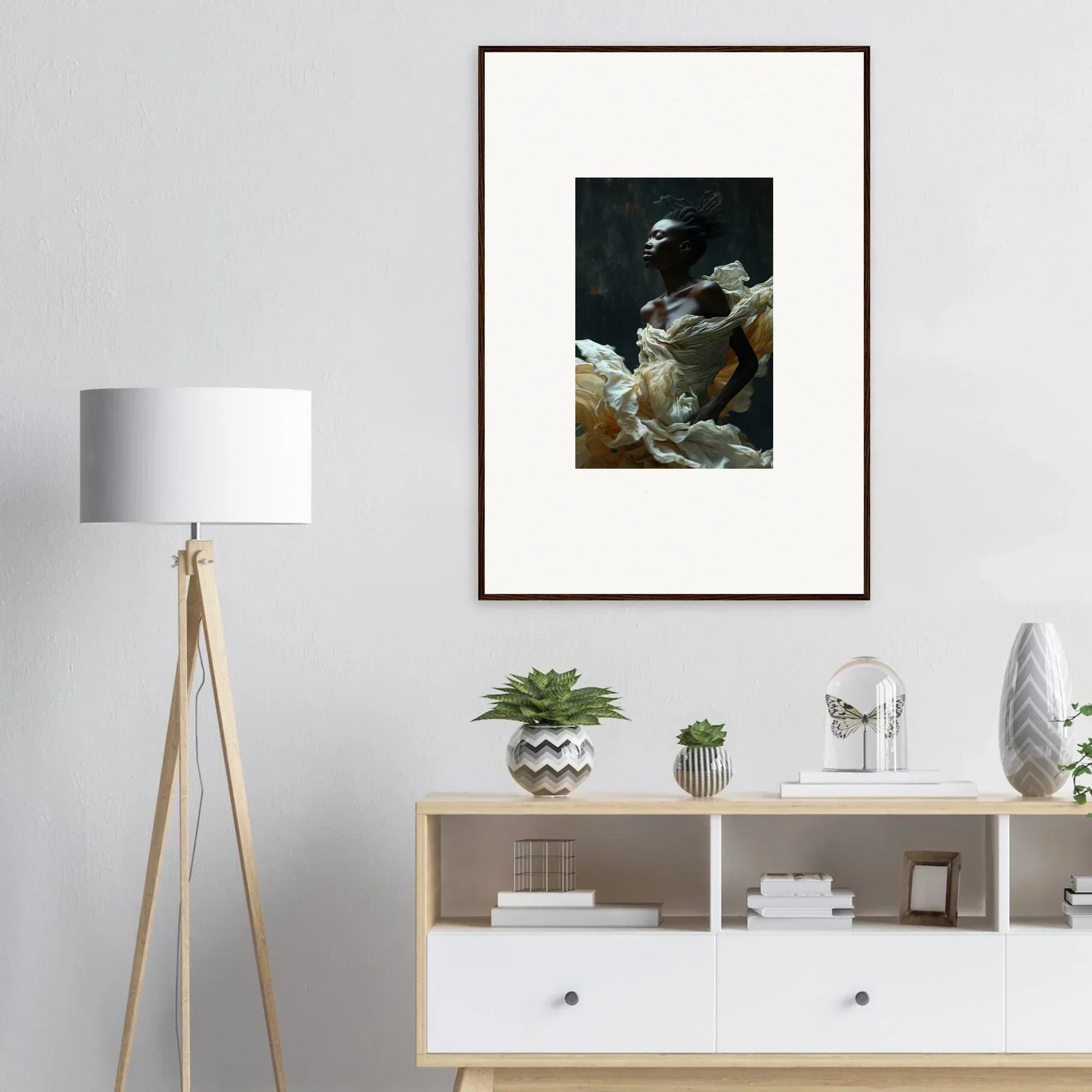 Framed artwork depicting a dark, moody scene with fabric or drapery.