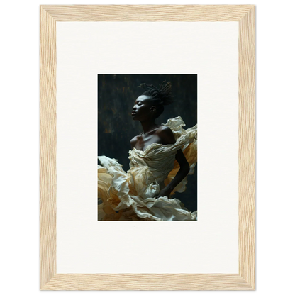 Framed photograph of a person emerging from billowing white fabric against a dark background.