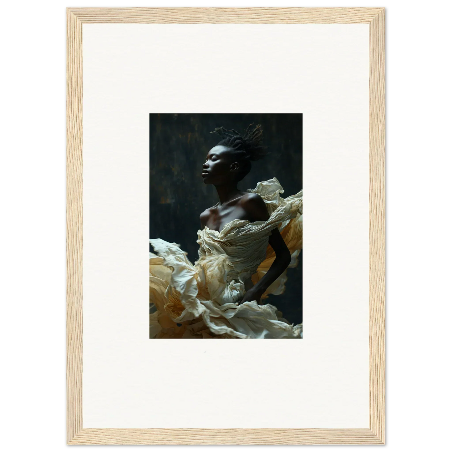 Framed portrait photograph of a person draped in flowing white fabric against a dark background.