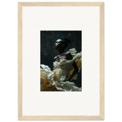 Framed portrait photograph of a person draped in flowing white fabric against a dark background.