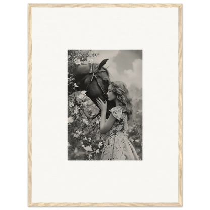 Young girl holding a big bird in a black and white canvas print for room decoration