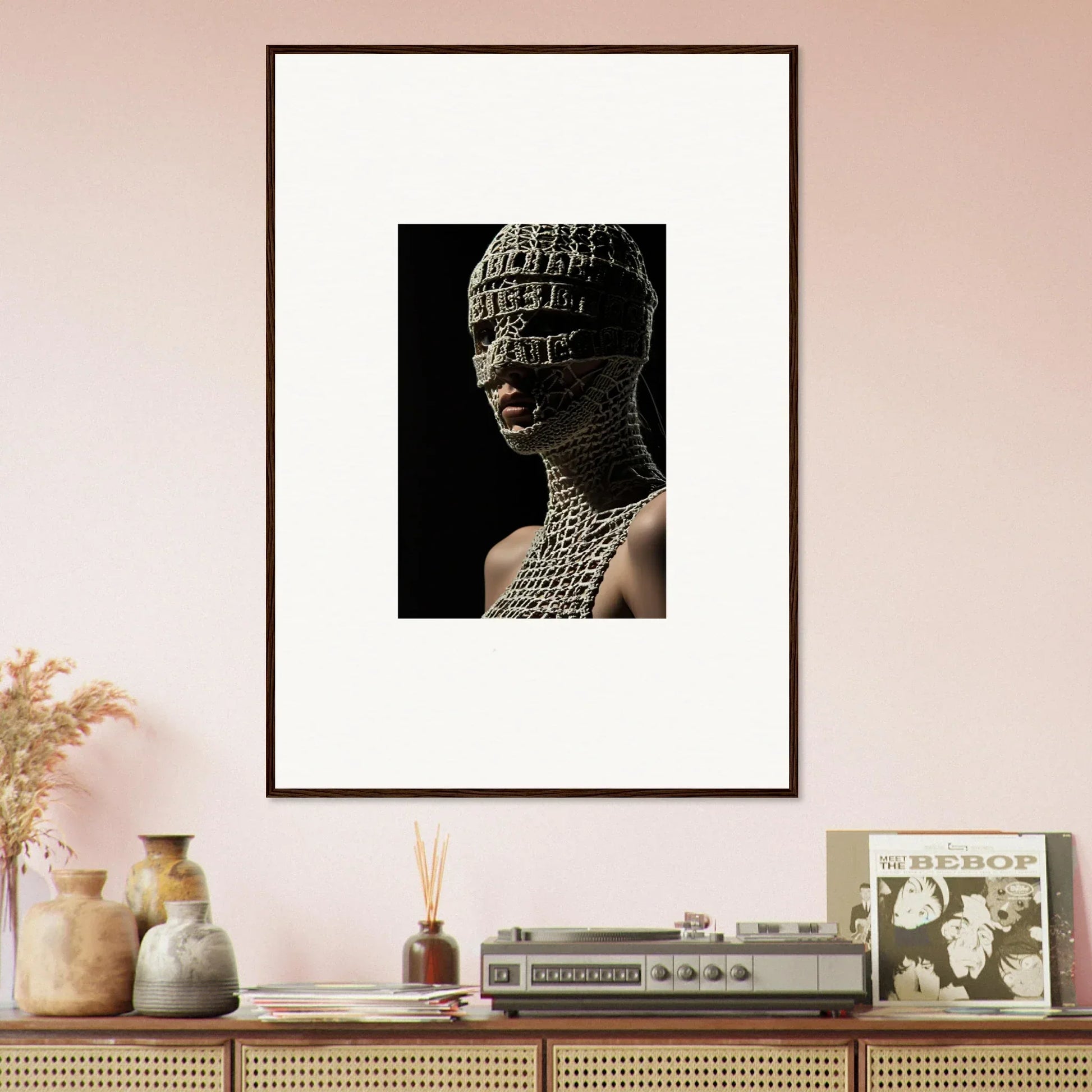 Framed artwork depicting a figure with a head and upper body covered in text or symbols.