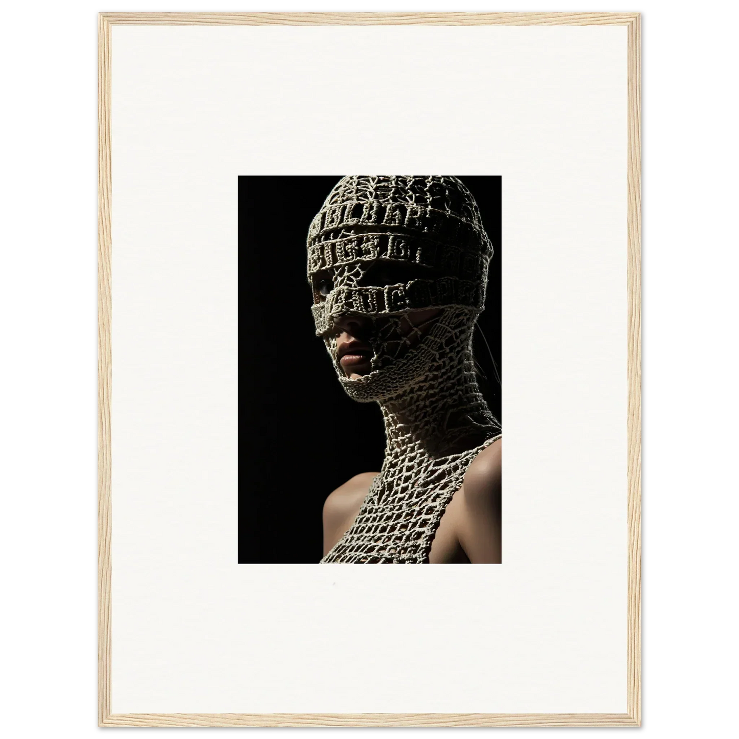 Striking portrait of a figure wearing an intricate metallic mesh mask and bodysuit covering their head and torso.