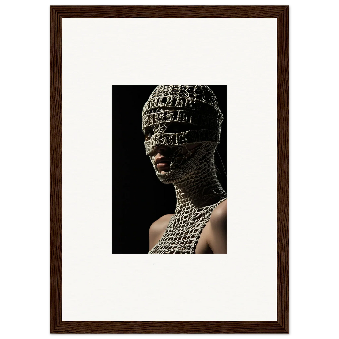 Framed photograph of a person wearing an intricate, textured head and neck covering.