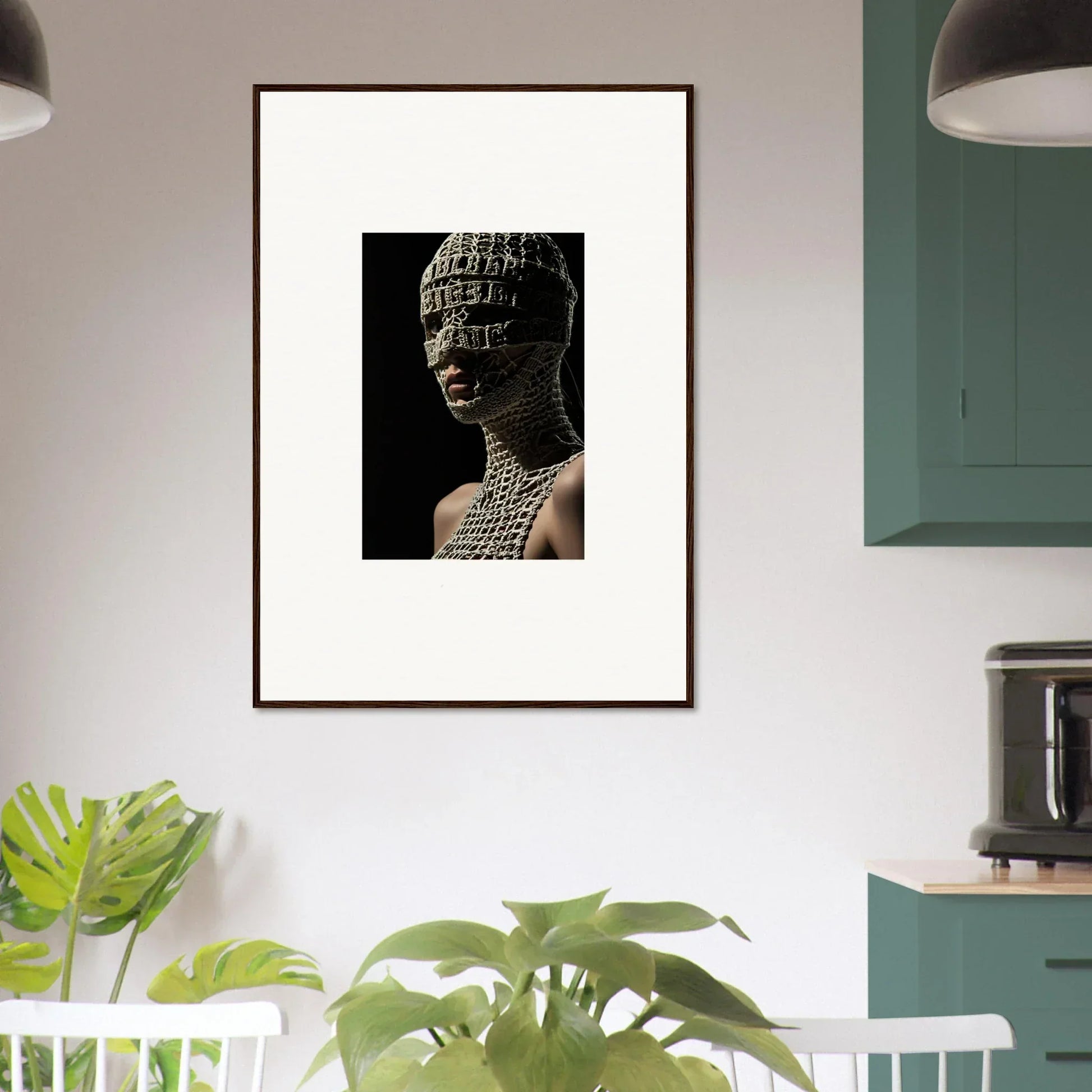 Framed artwork depicting a sculptural bust covered in text or symbols.