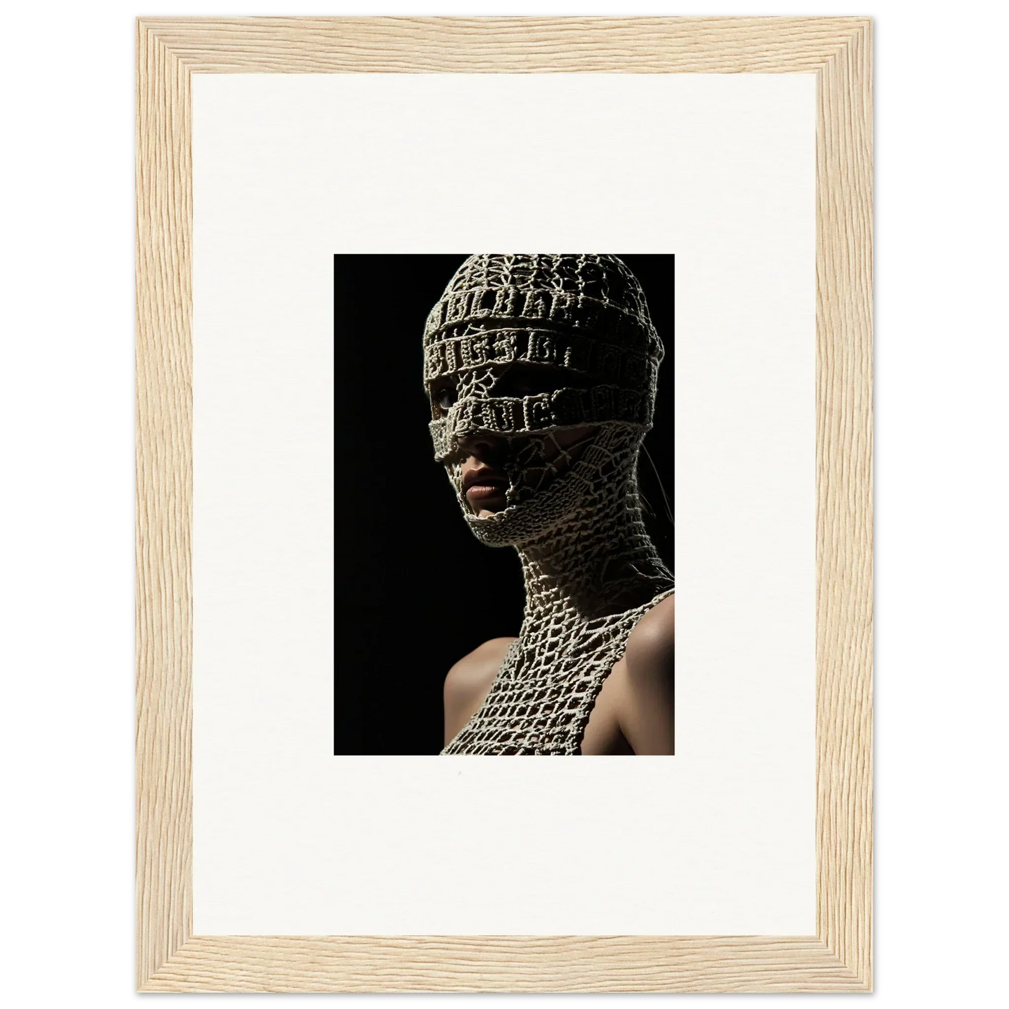 Framed photograph of a person wearing an intricate, textured head and neck covering.