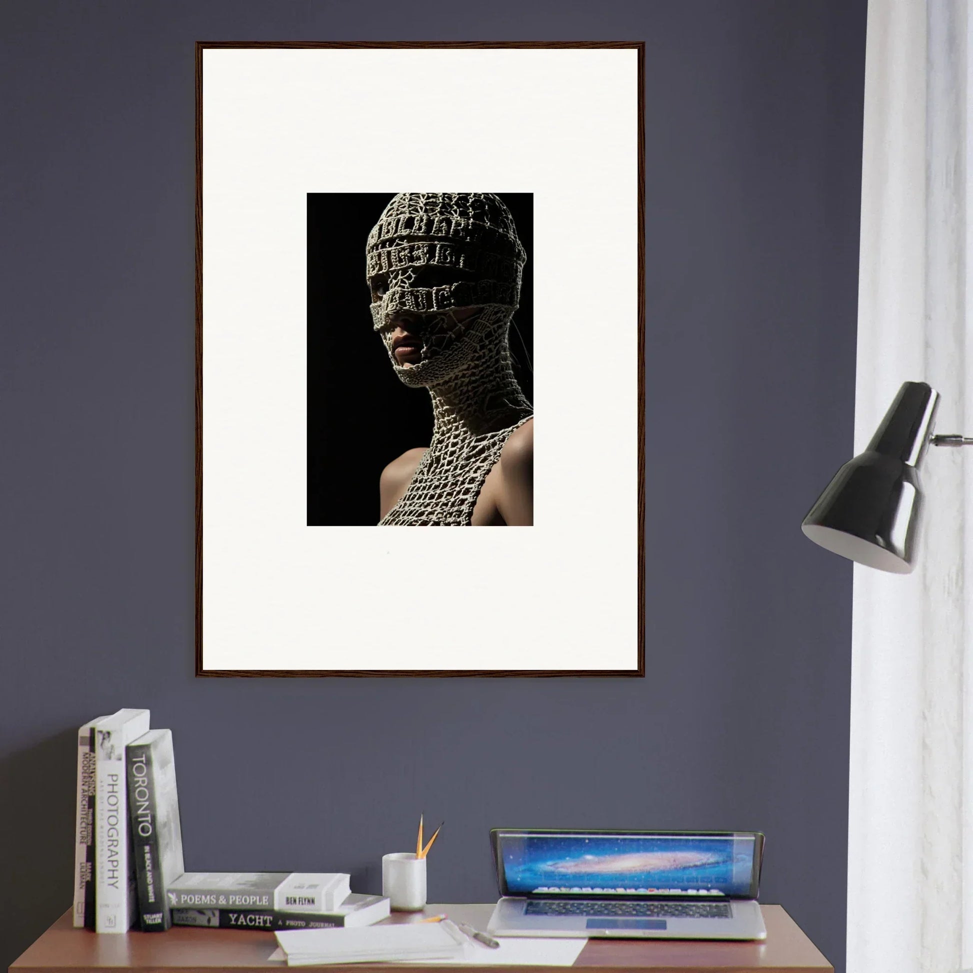 Framed artwork depicting a human head covered in text or symbols against a dark background.