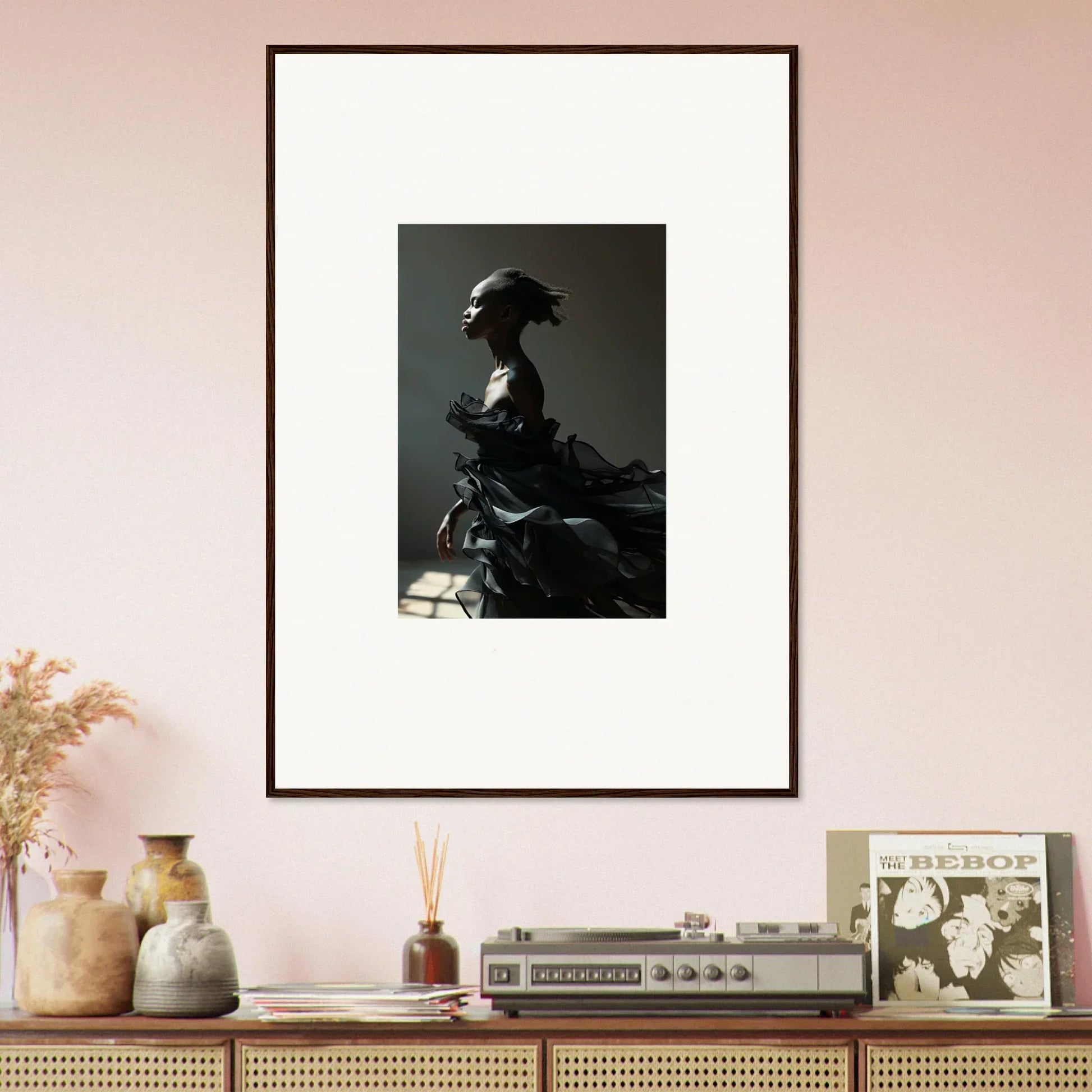 Framed black and white wall art of a silhouetted figure in Black Alchemy costume