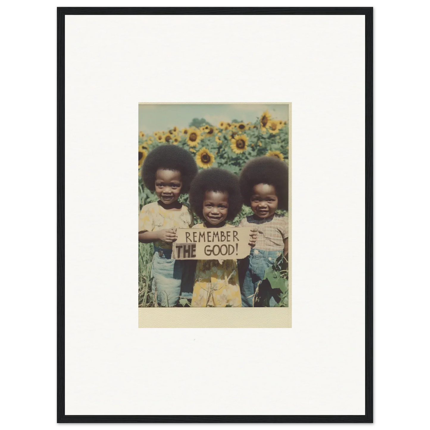 Framed photograph of kids with Remember the good sign in a sunflower field for bloom moments