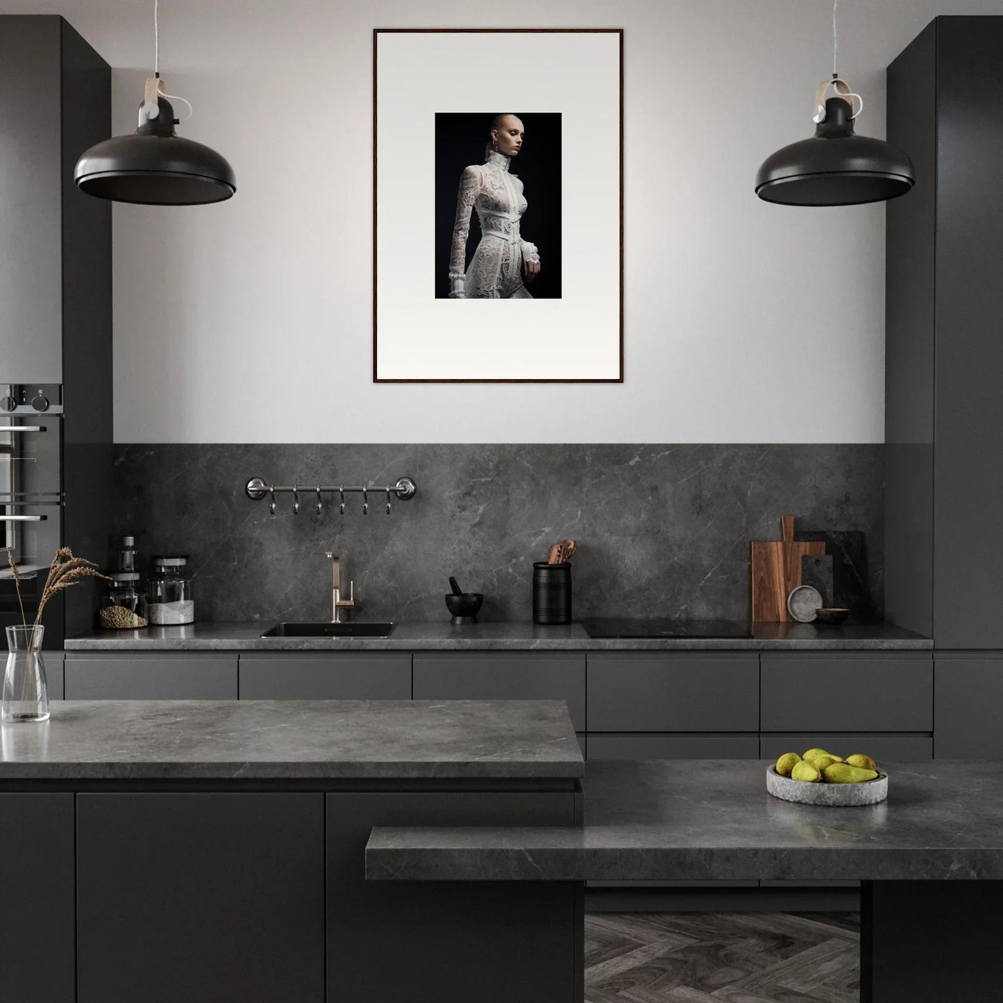 Modern kitchen with dark cabinetry and a framed black-and-white portrait on the wall.