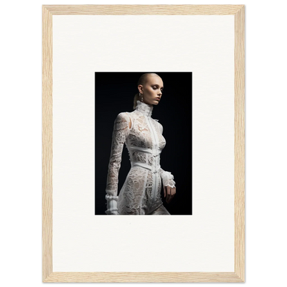 Framed photograph of a person wearing an intricate white lace dress with a high collar and long sleeves.