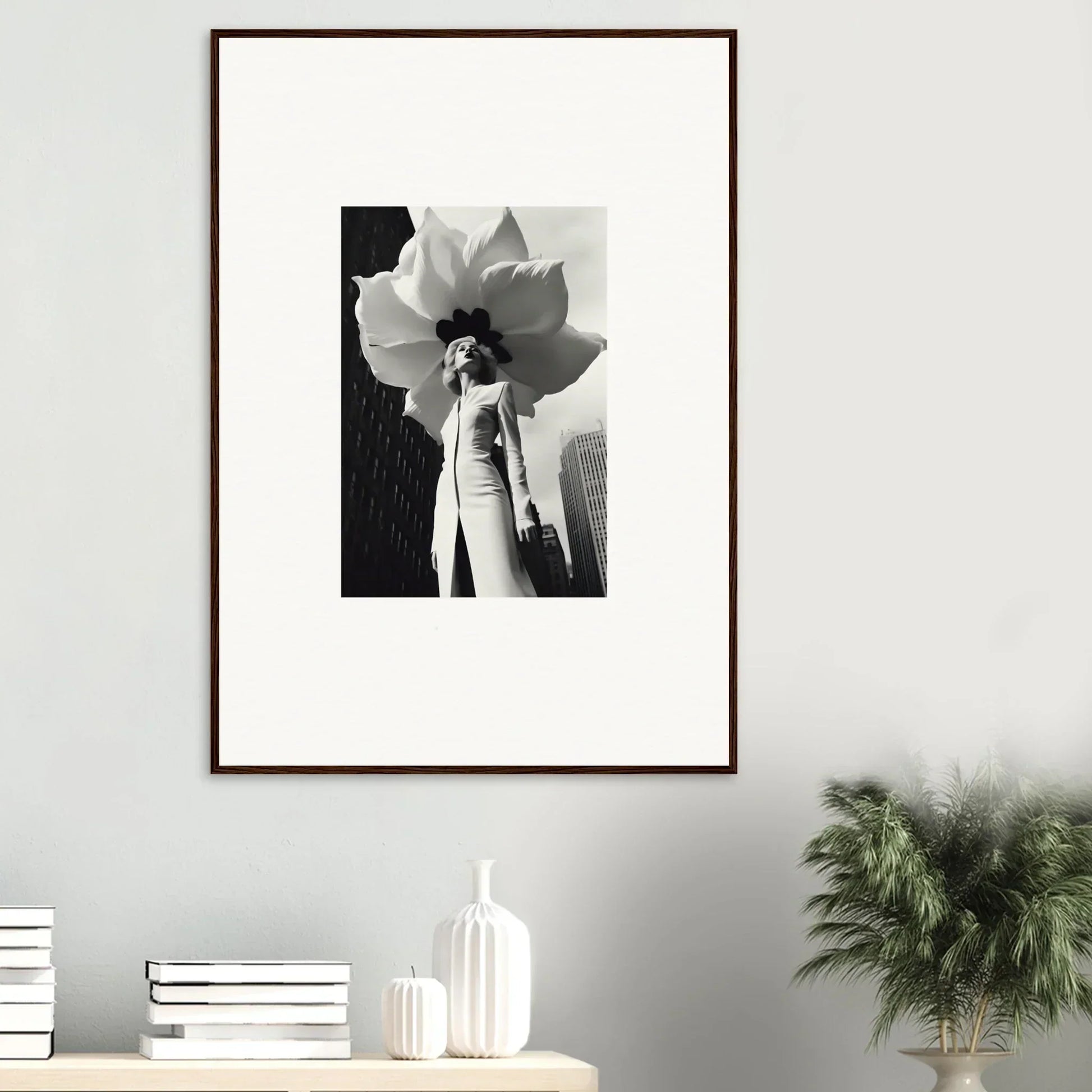 Framed black and white photo of a person with a large flower, perfect for room decoration