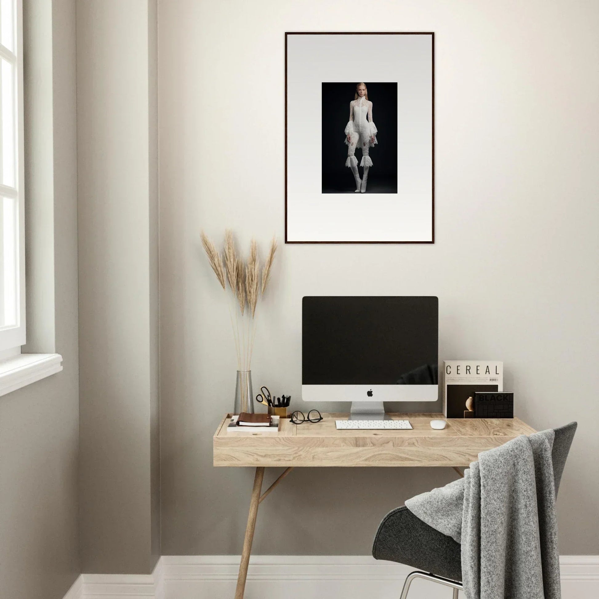 Minimalist home office with wooden desk, computer, and framed wall art for room decor