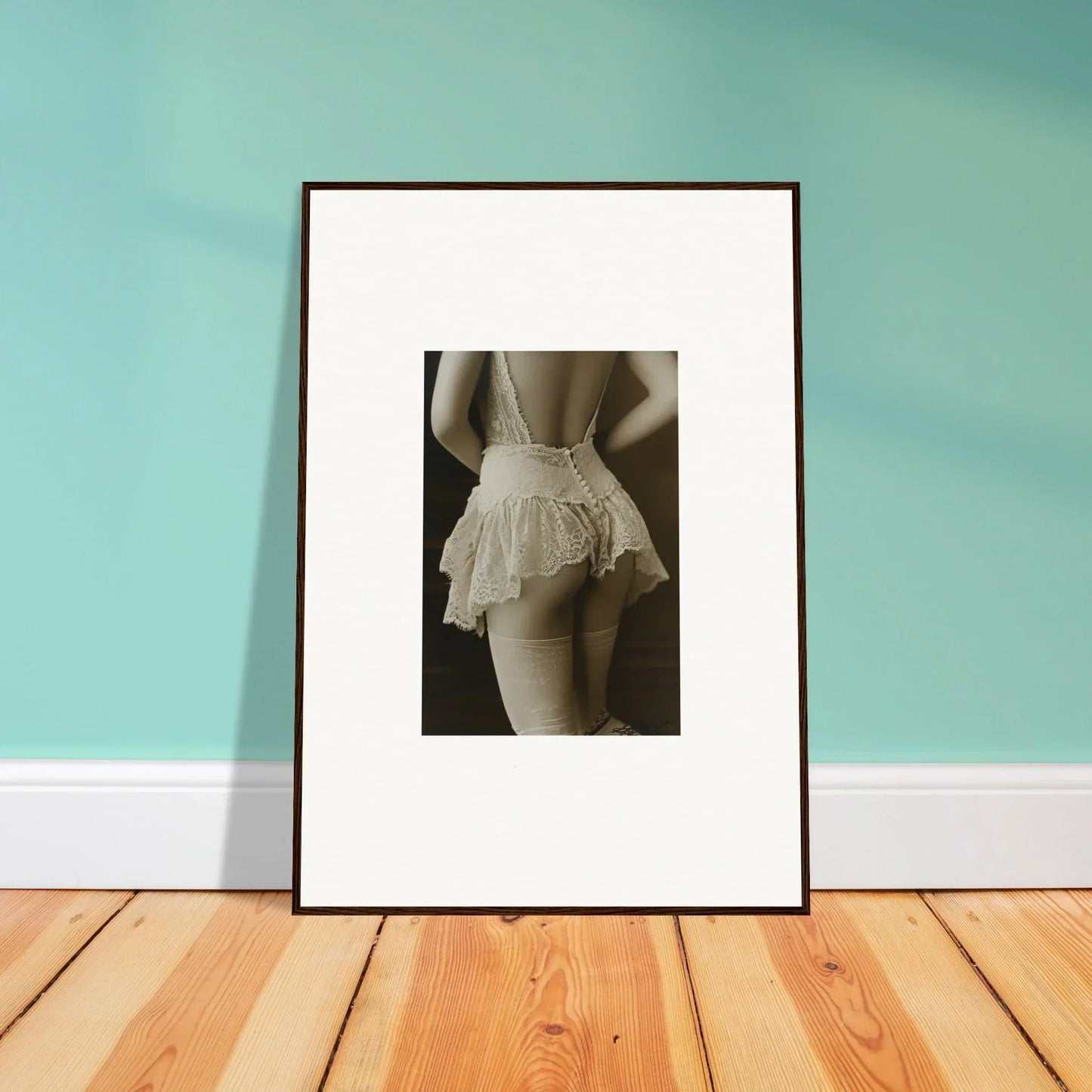 Framed black and white photo of a person in a ruffled skirt, perfect wall art for room decoration