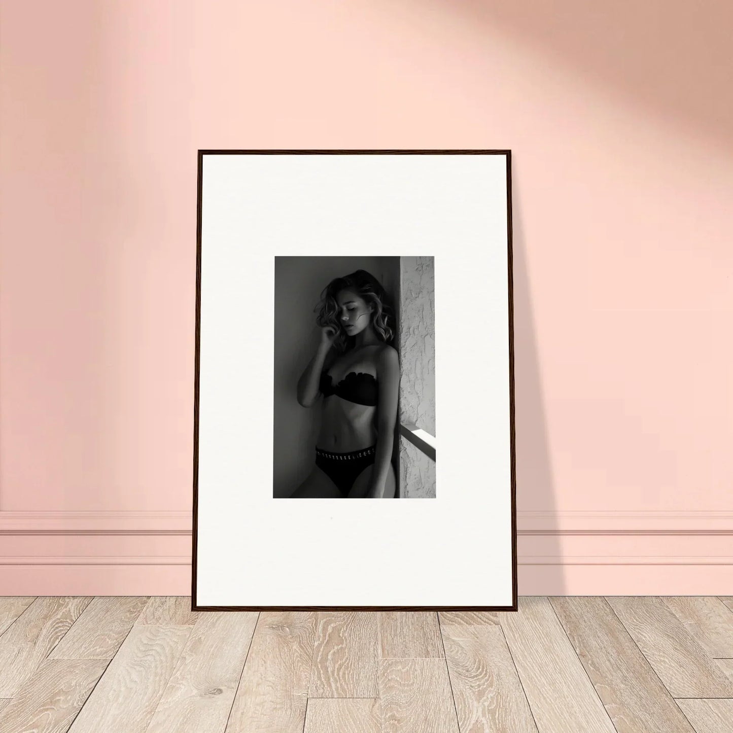 Framed black and white photograph of a person in undergarments.