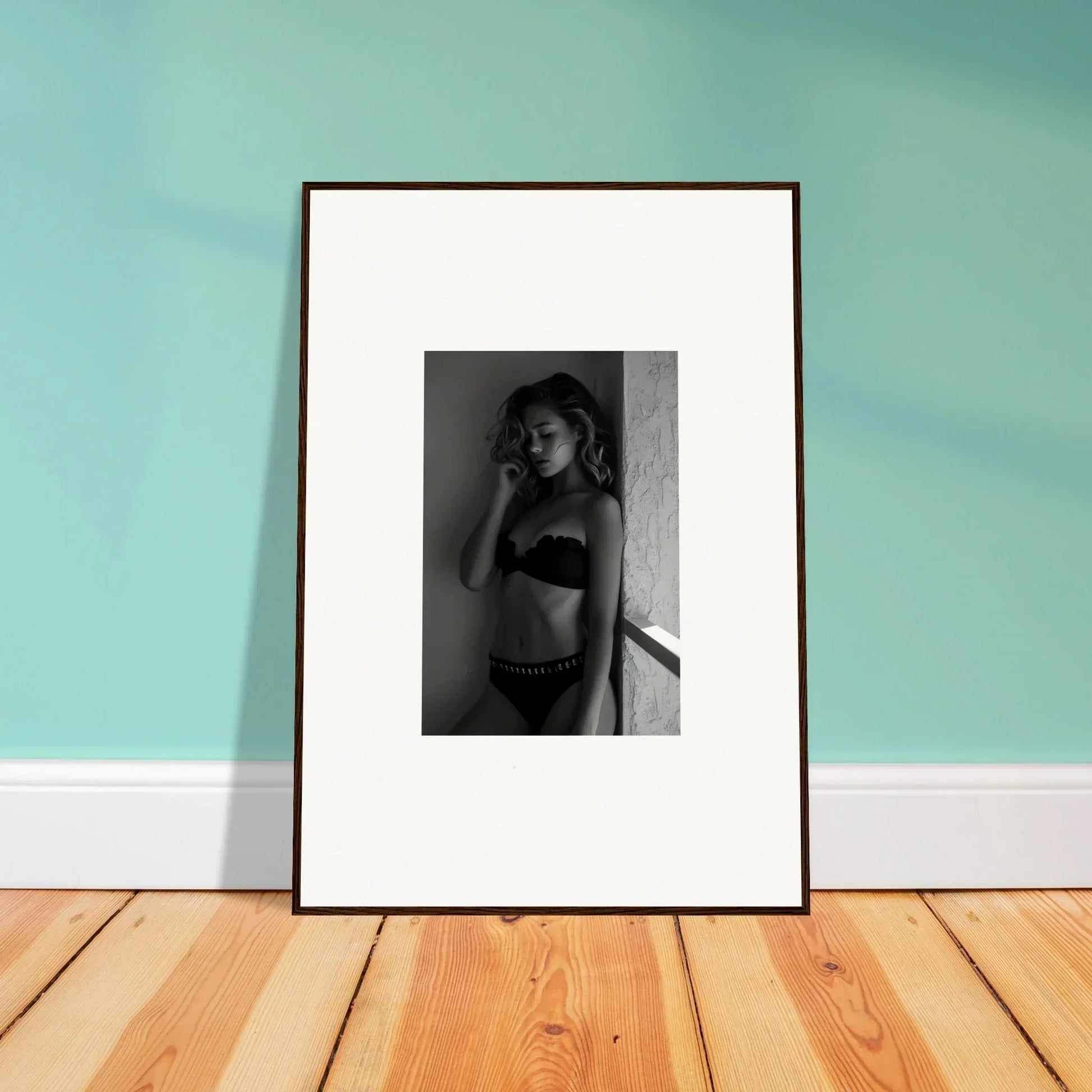 Framed black and white photograph of a woman in lingerie.