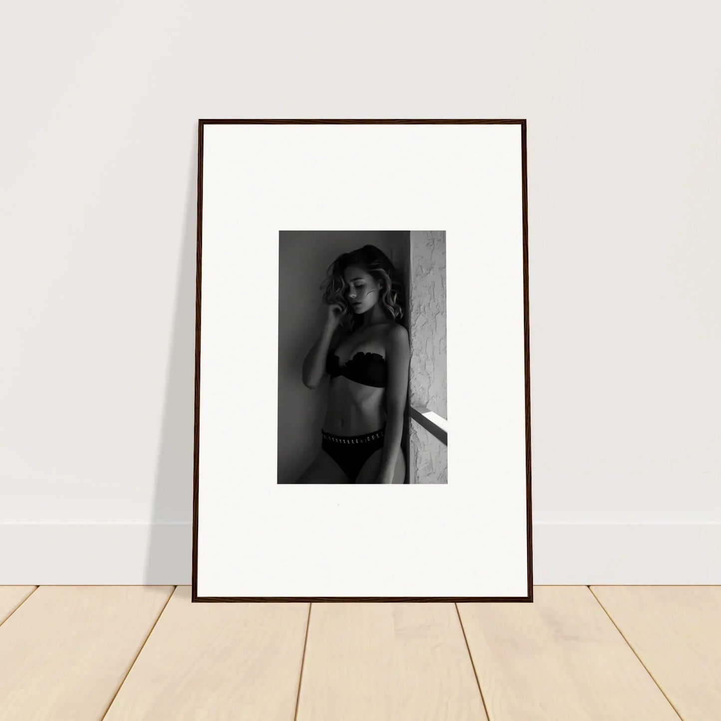 Framed black and white photograph of a woman in underwear.