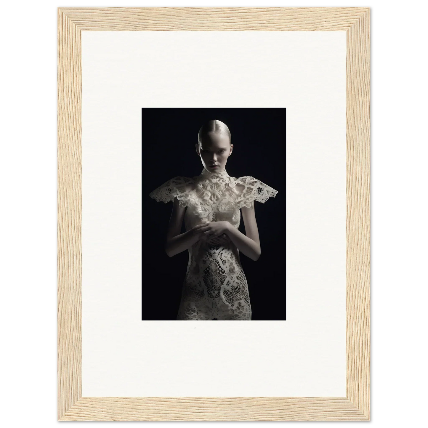 Framed black and white photograph of a figure in an ornate white garment, lace echoes wall art