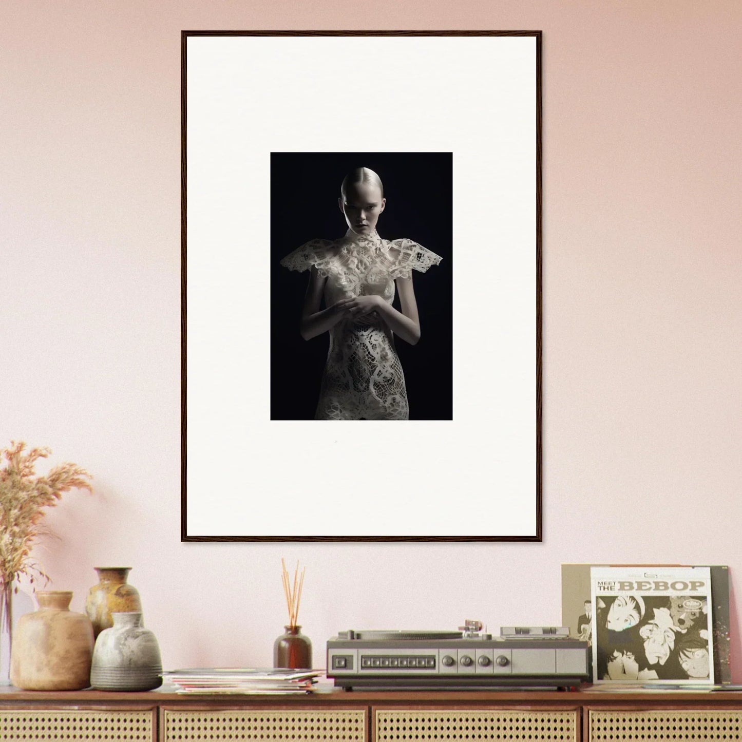 Framed black and white wall art of a sculptural figure in ornate garment for room decor