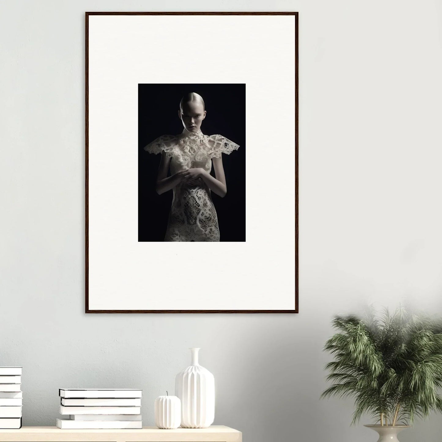 Framed wall art of a figure in lace echoes dress holding a flower for elegant room decor