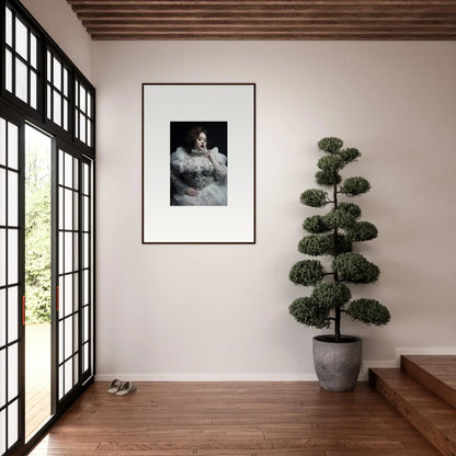 Framed black and white portrait photograph hanging on a white wall.