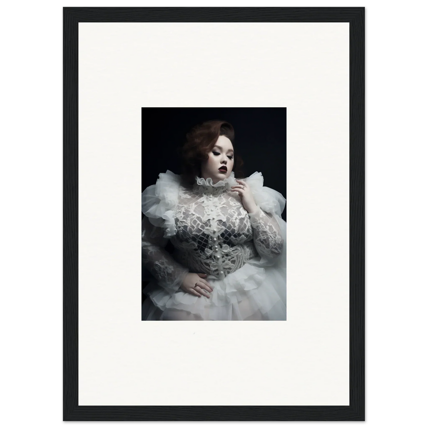 Dramatic black and white portrait of a woman in an ornate white gown with voluminous ruffles and lace details.