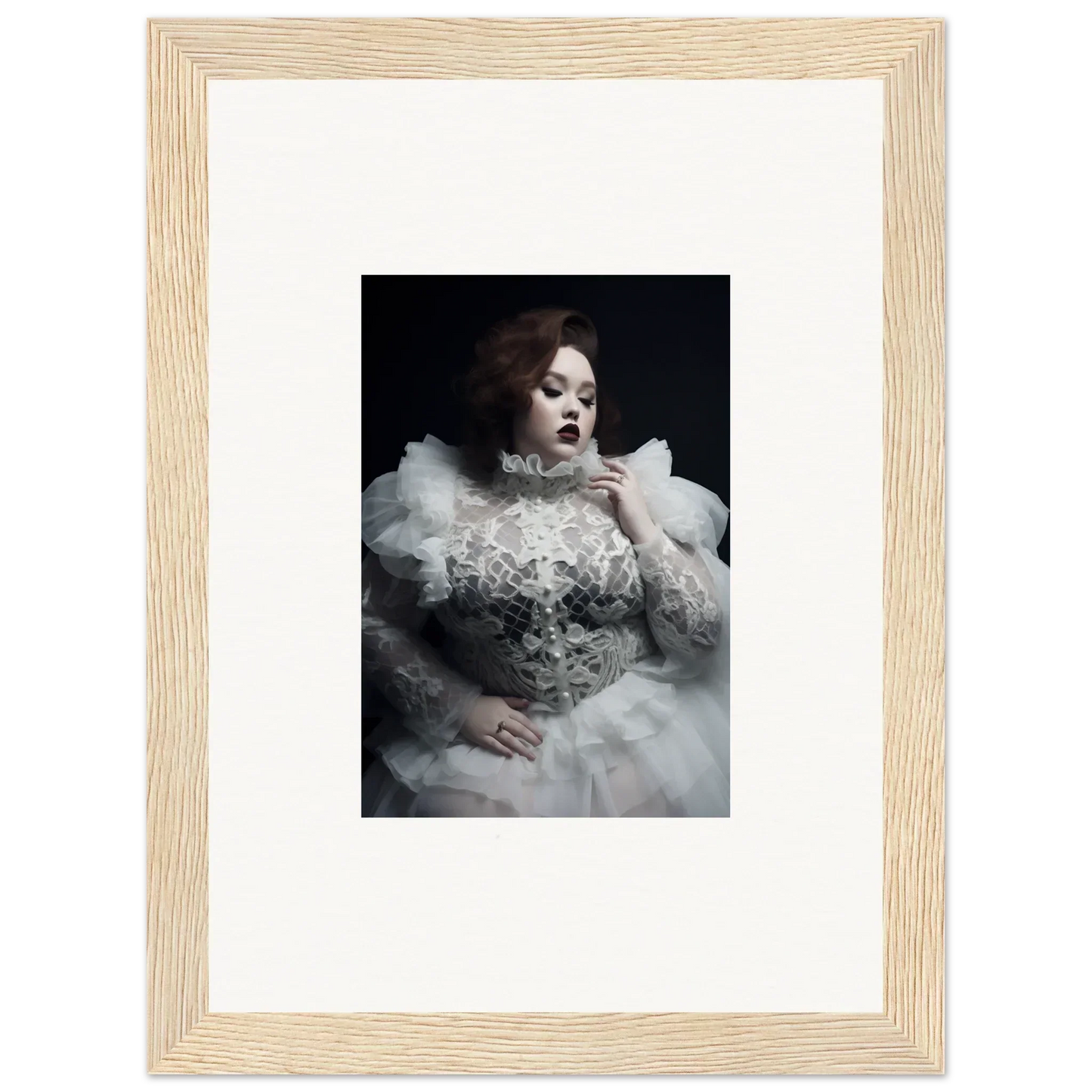 Framed black and white photograph of a woman in an elaborate white gown with voluminous ruffles.