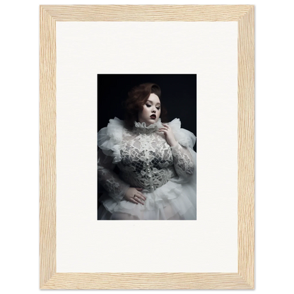 Framed black and white photograph of a woman in an elaborate white gown with voluminous ruffles.