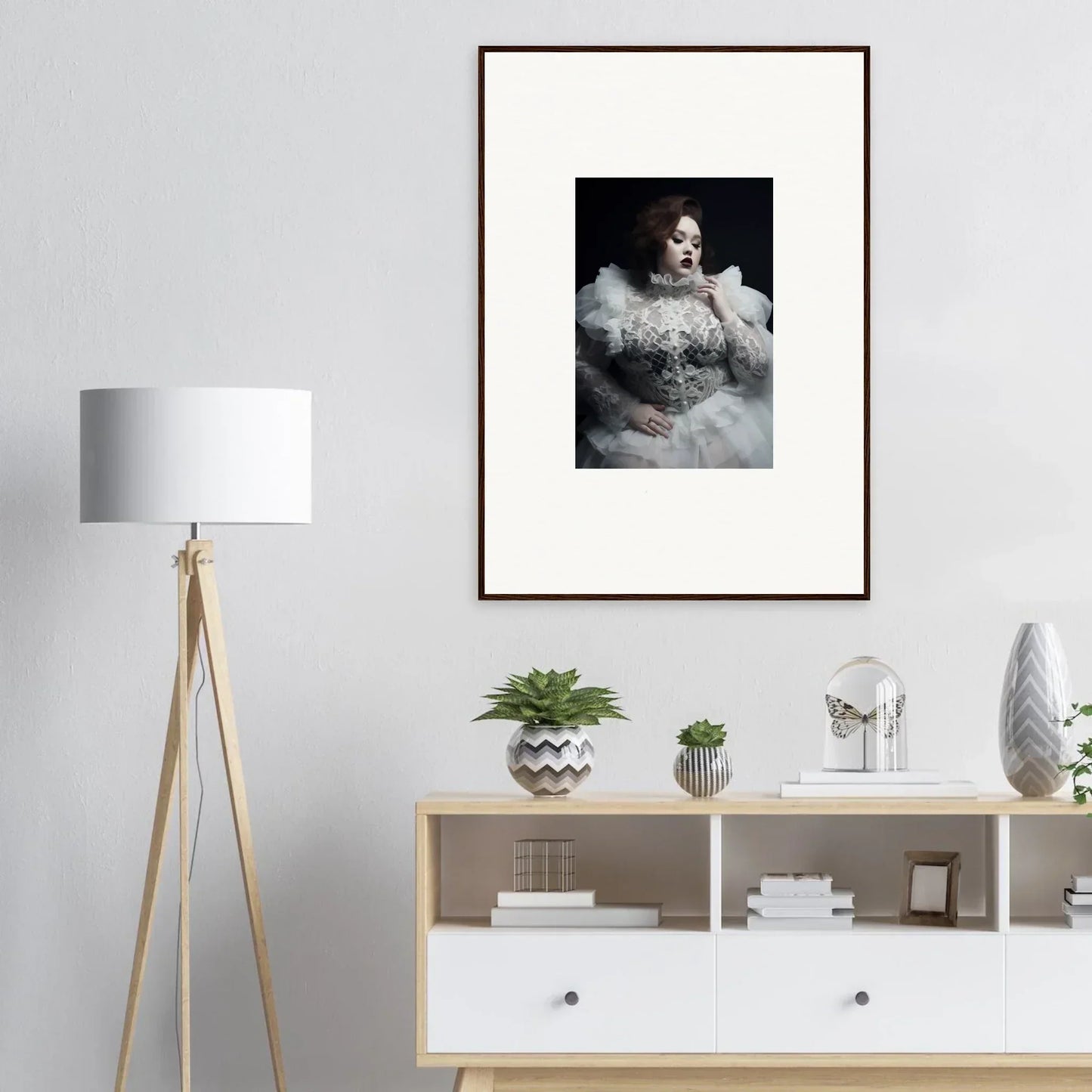 Framed black and white portrait photograph of a person surrounded by billowing fabric or clouds.