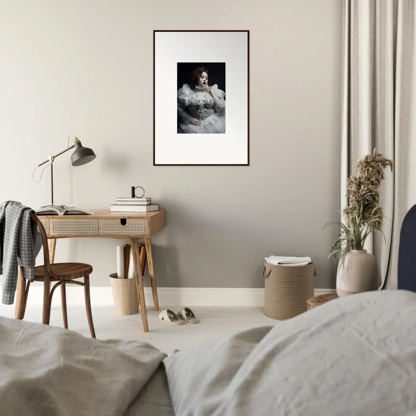 Framed black and white portrait photograph hanging on a wall.