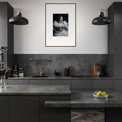 Modern kitchen with dark cabinetry and a framed black-and-white portrait on the wall.