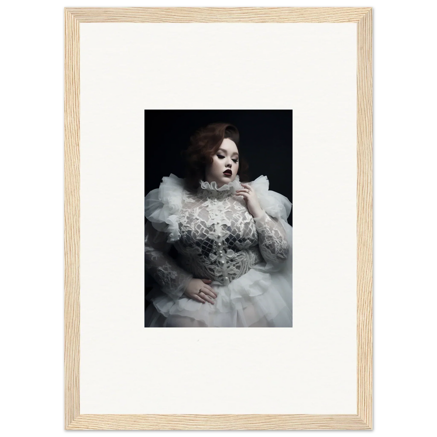 Framed black and white photograph of a woman in an ornate white dress with voluminous ruffles and lace details.