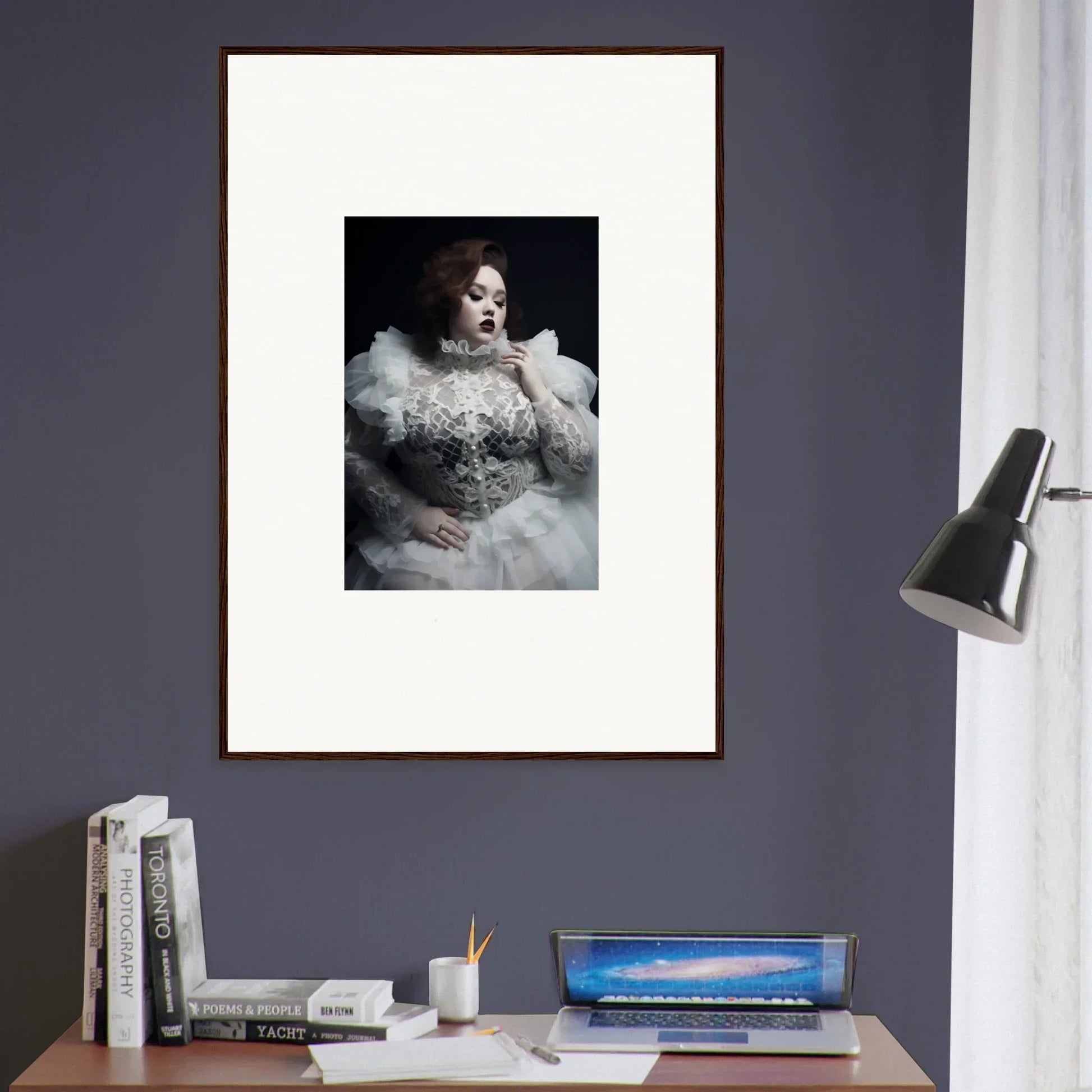 Framed portrait photograph of a person wearing an ornate white dress with a ruffled collar.