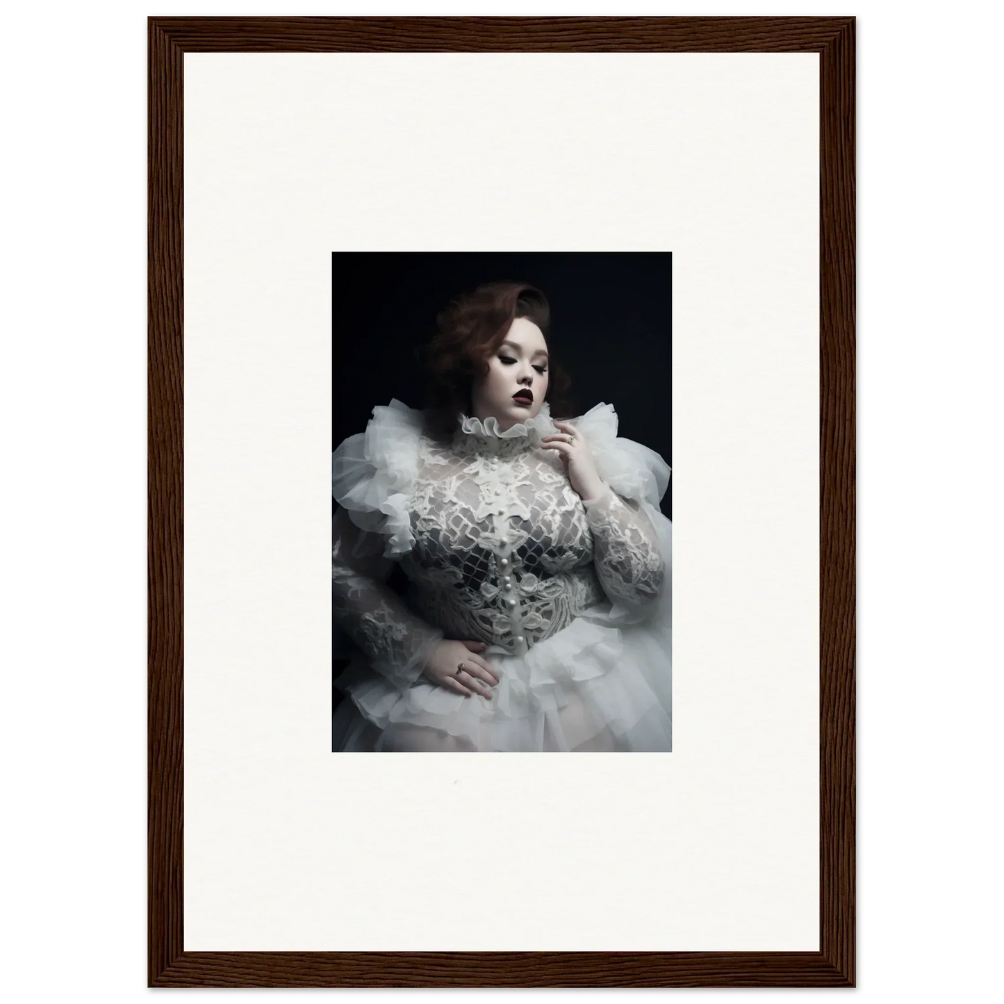 Framed portrait photograph of a woman in an elaborate white gown with ruffles and lace.