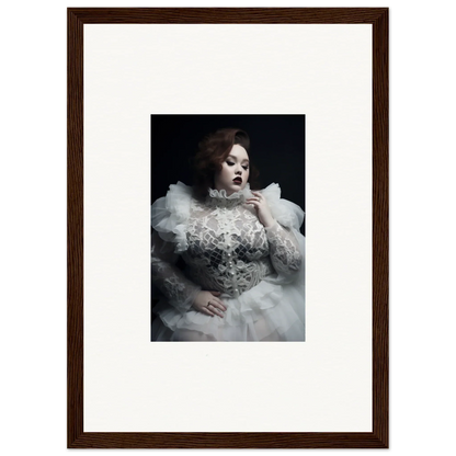 Framed portrait photograph of a woman in an elaborate white gown with ruffles and lace.