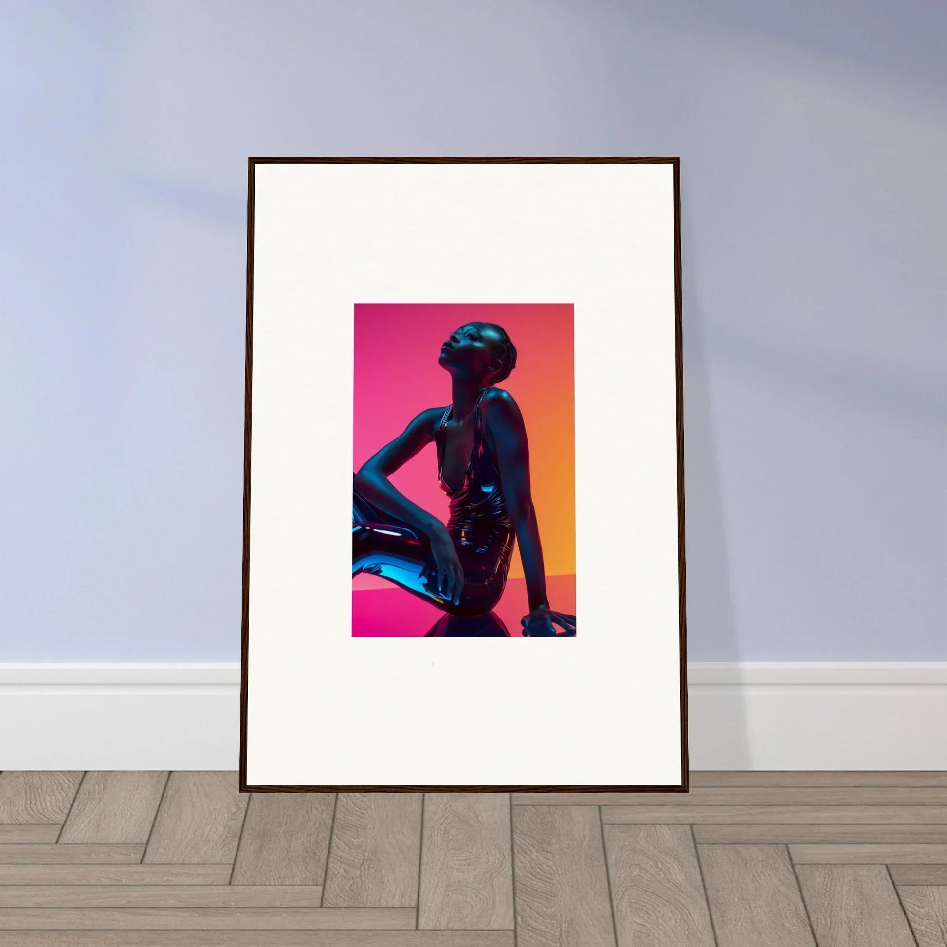 Framed wall art of a silhouetted figure with vibrant neon echoes in pink and orange