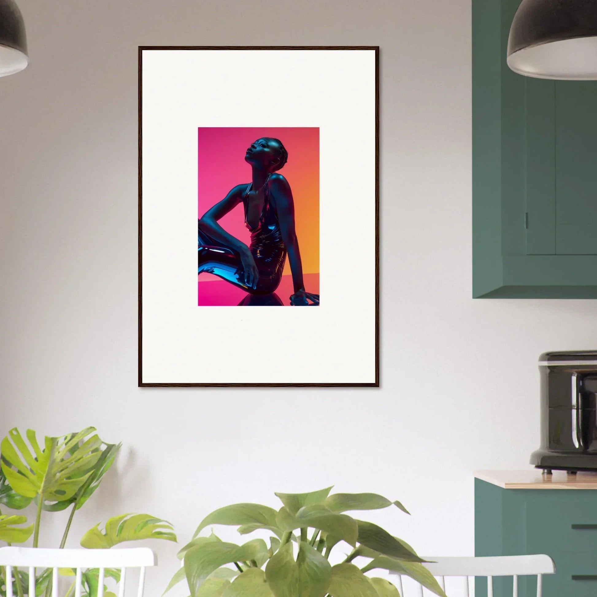 Framed wall art of a silhouetted figure in neon echoes on a pink and orange background