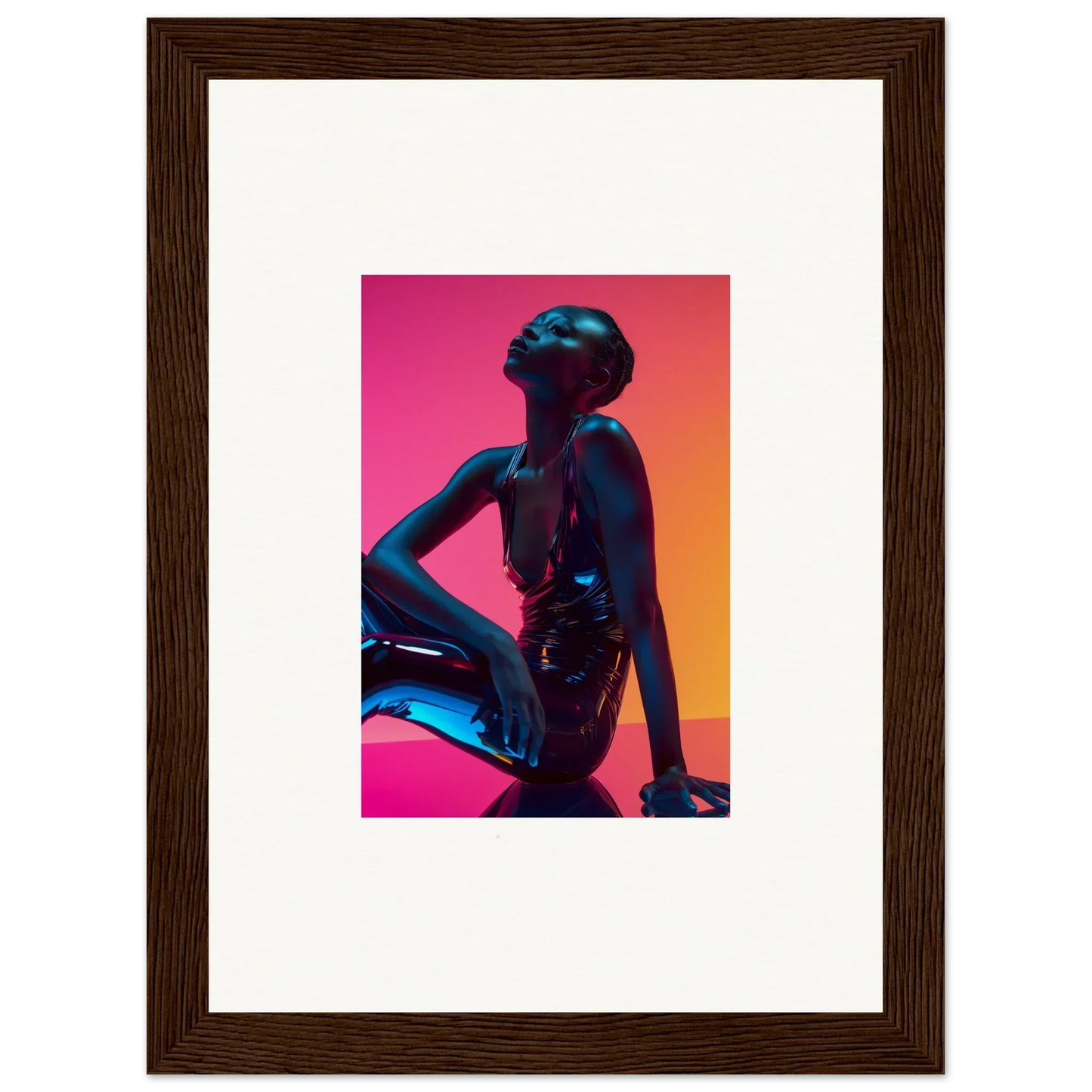 Framed wall art of a silhouetted figure with neon echoes in pink and orange hues