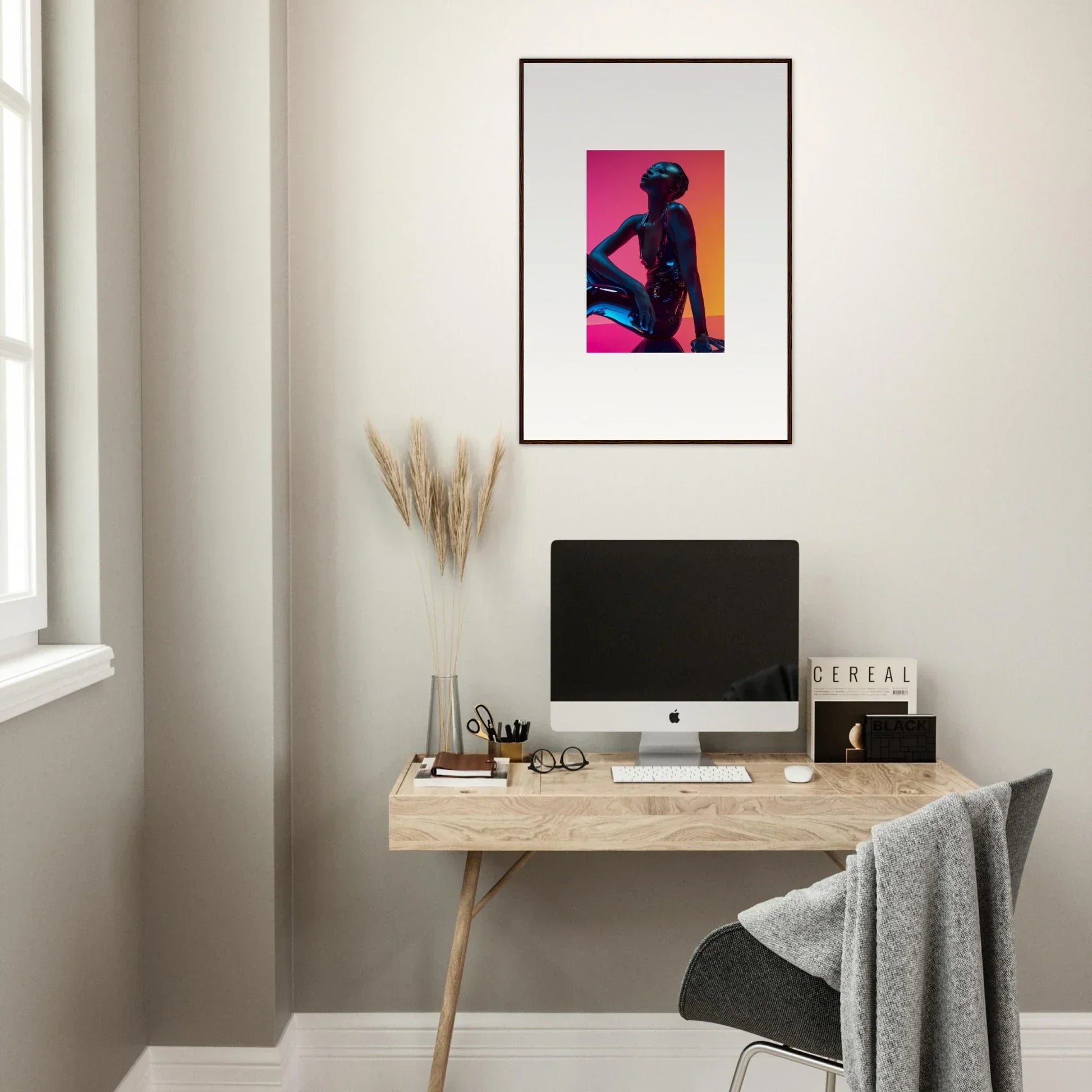 Minimalist home office with neon echoes, wooden desk, computer, and framed wall art