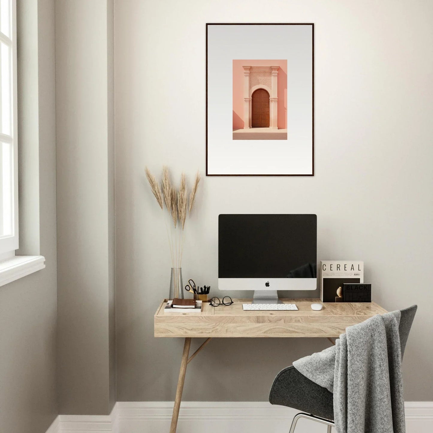 Minimalist wooden desk with iMac and Ethereal Sun Portal framed wall art above