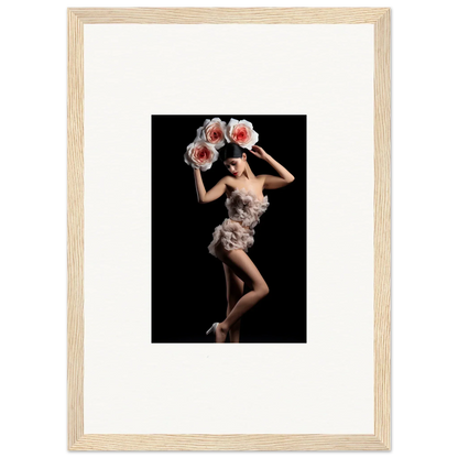 Framed wall art of a dancer in a feathered costume amidst a floral heist