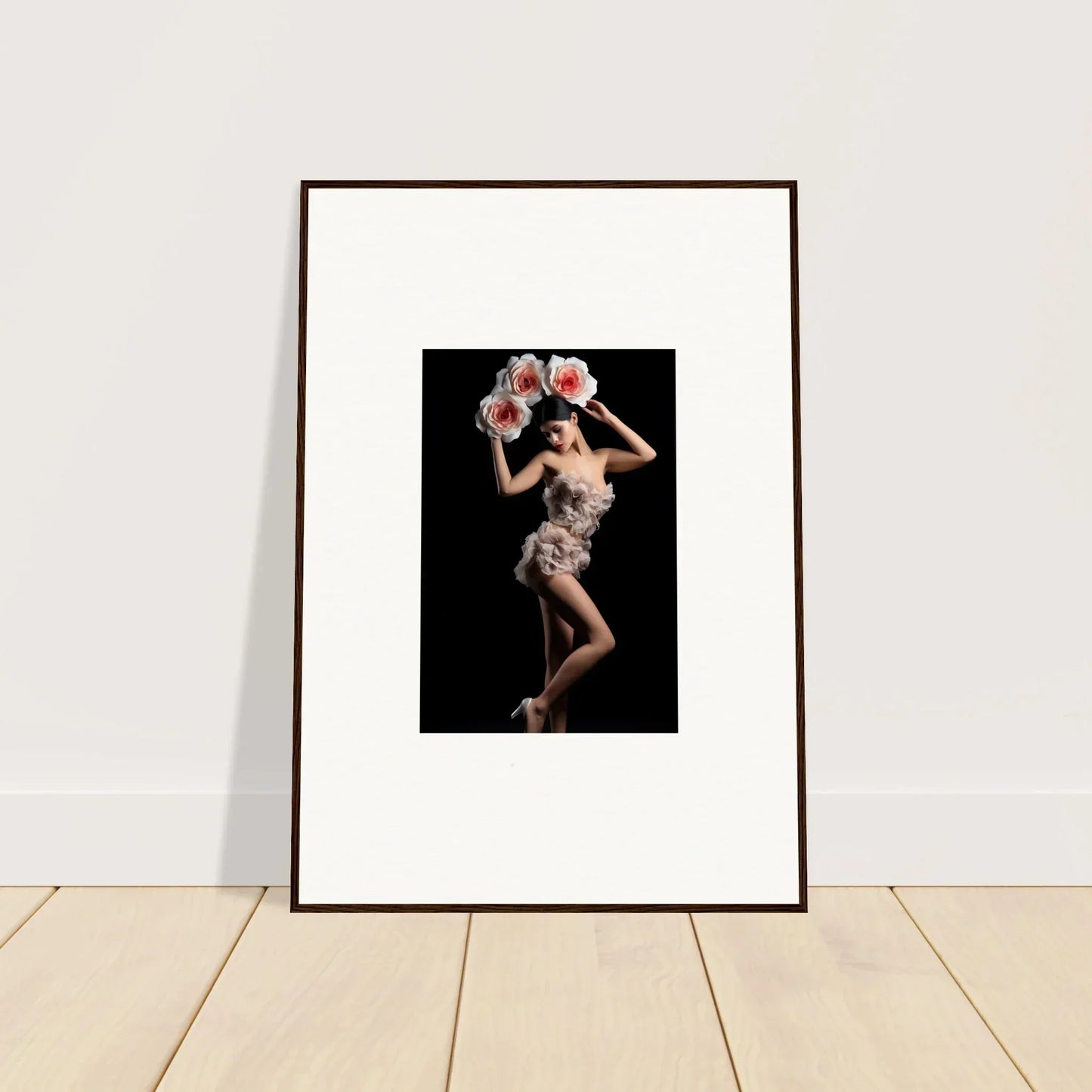 Framed wall art of a person with pink flowers in a floral heist room decor style