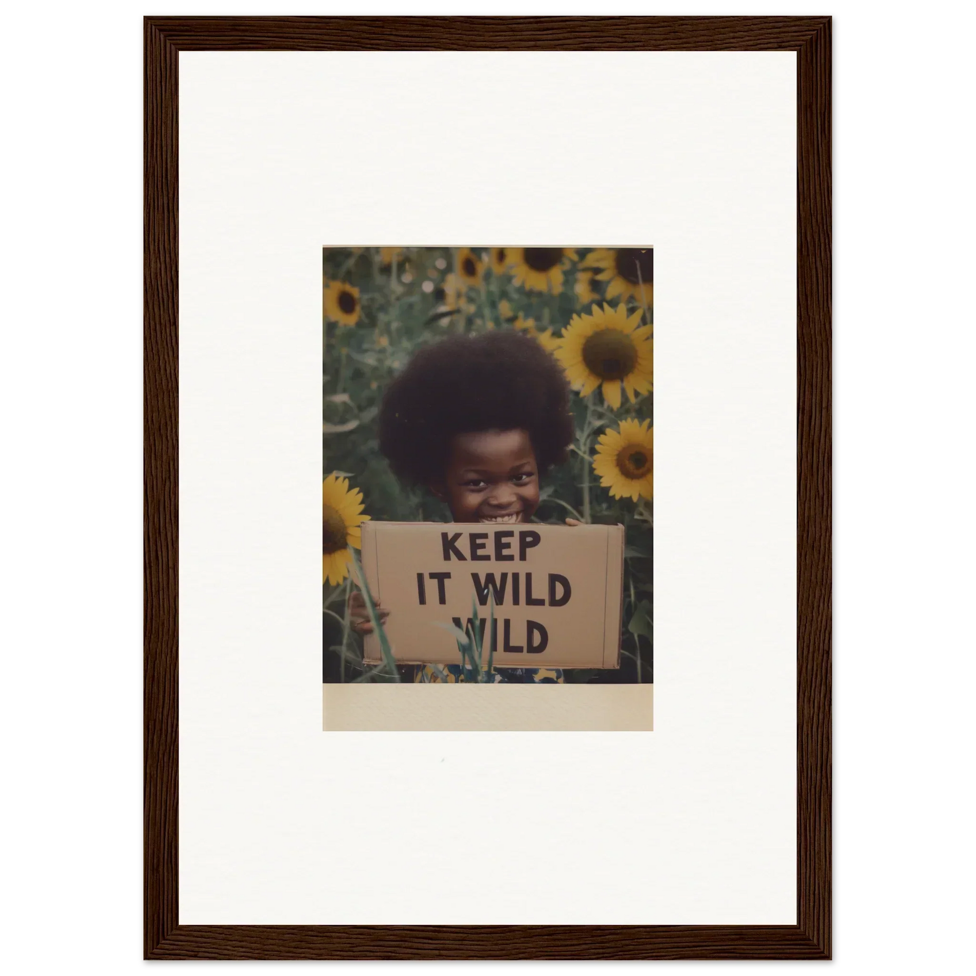 Person holding KEEP IT WILD sign in sunflowers for Euphoric Sun Voyages special edition art™