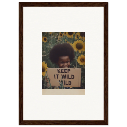 Person holding KEEP IT WILD sign in sunflowers for Euphoric Sun Voyages special edition art™