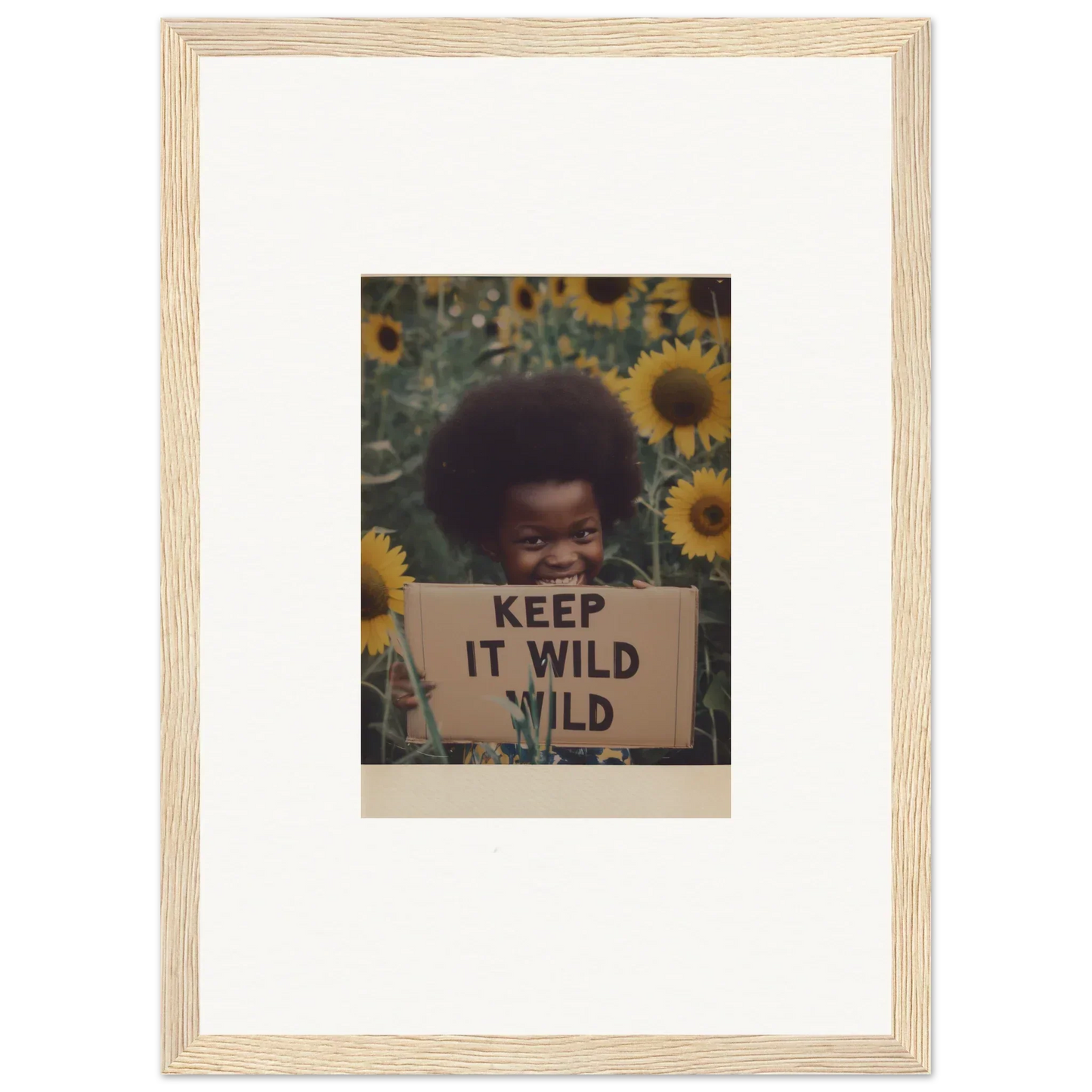 Framed photo of a person with a KEEP IT WILD sign in sunflowers for Euphoric Sun Voyages