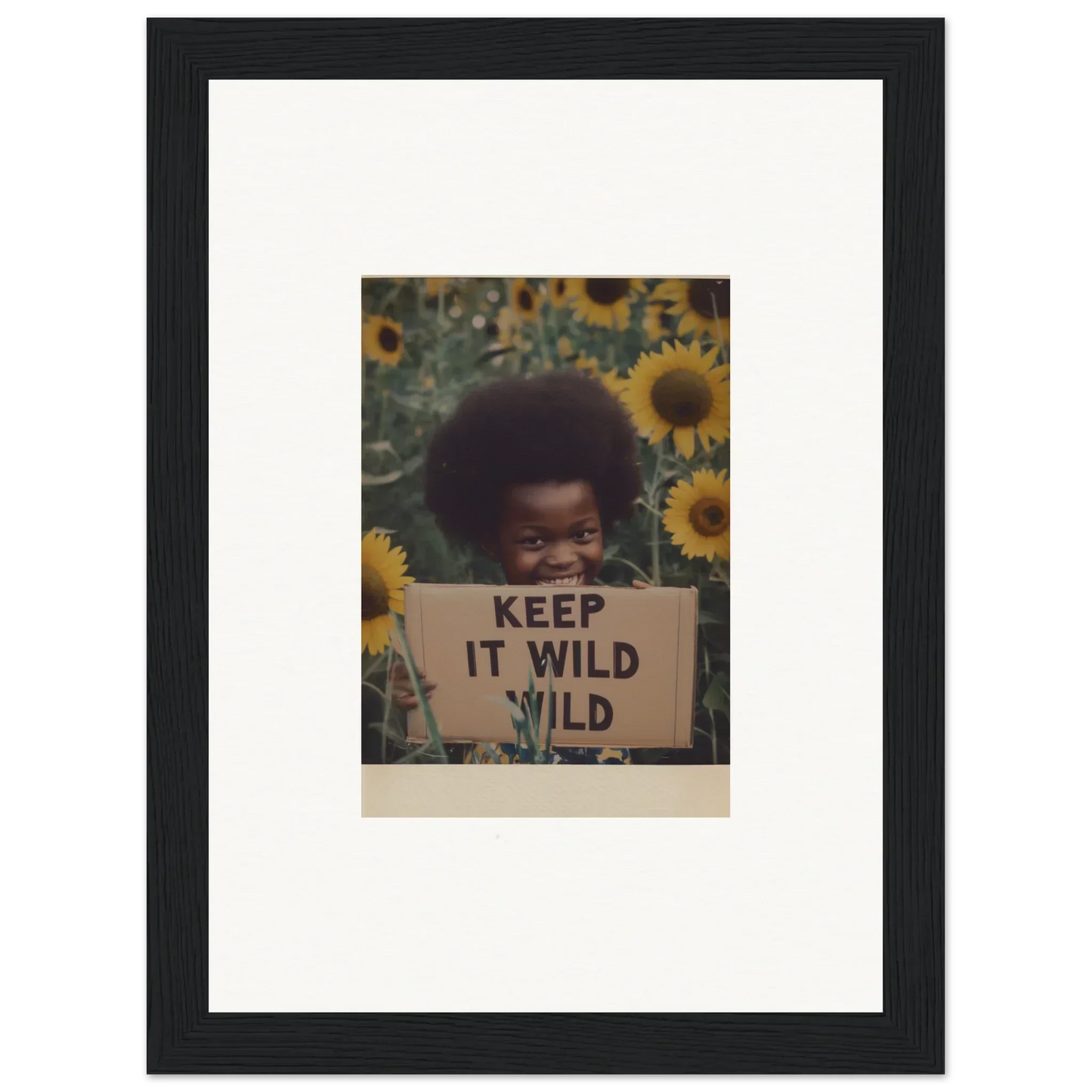 Framed photograph with a KEEP IT WILD sign surrounded by sunflowers from Euphoric Sun Voyages