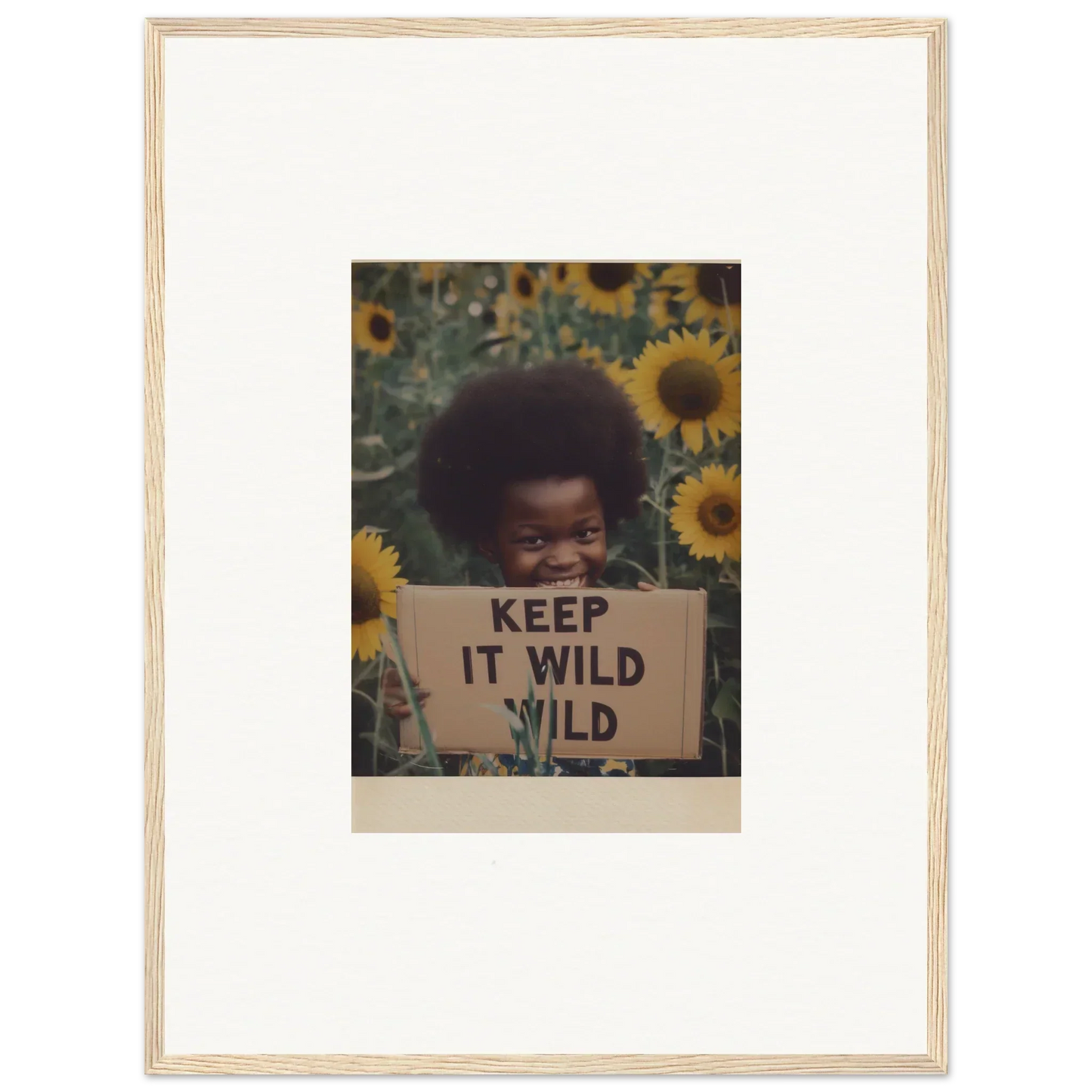 Framed photo of sunflowers and a KEEP IT WILD sign from Euphoric Sun Voyages