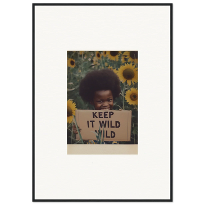 Framed vintage photo of a person with a KEEP IT WILD sign in sunflowers for Euphoric Sun Voyages