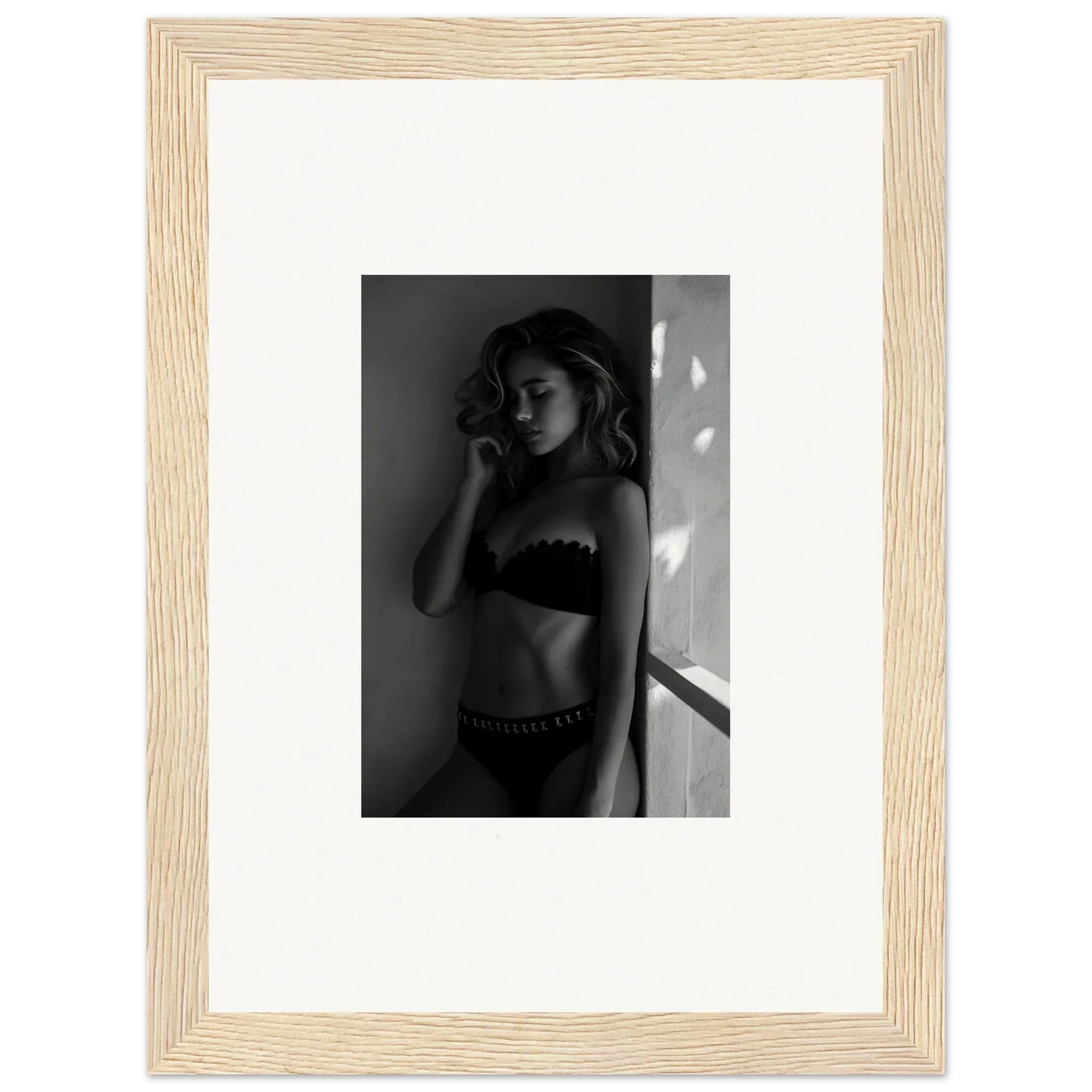 Framed black and white photograph of a woman in lingerie.