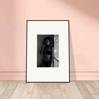 Framed black and white photograph of a person in undergarments.